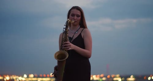 Saxophone Performance at Night with City Lights