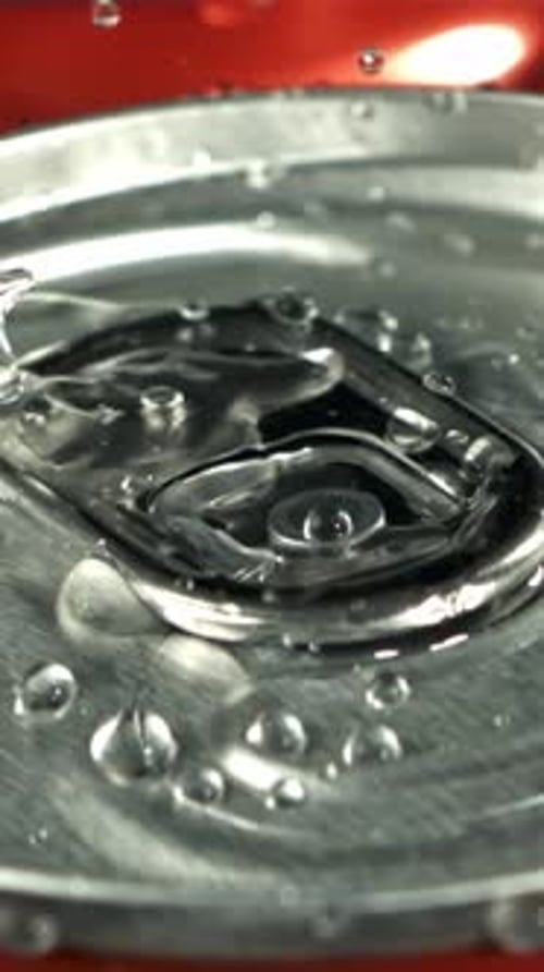 Drops of Water Fall on a Can of Cola