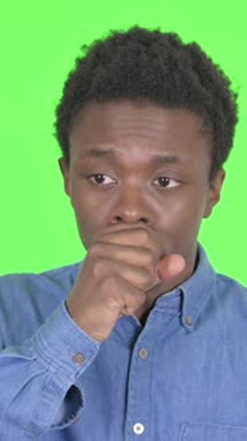 Coughing Sick Young African Man on Green Background, Vertical Video