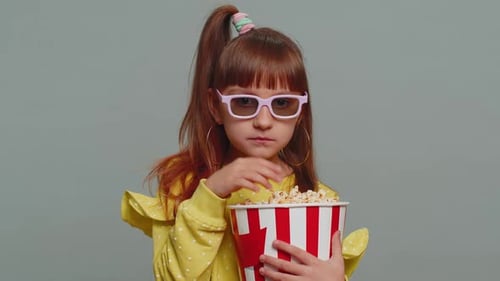 Girl Eating Popcorn Wearing 3D Glasses
