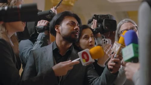 Man Answers Questions at Press Conference