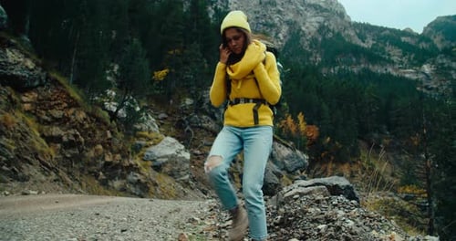 Woman Hiking with Tourist Backpack on Autumn Vacation Mountain Trip at Rainy Day