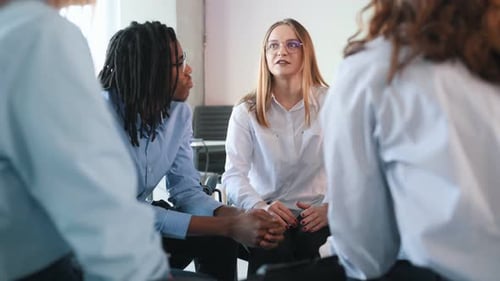 Group of adults sitting in a circle talking