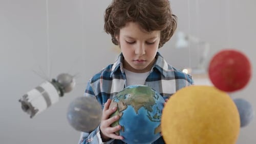 Cute spaceman boy imagination of flying travel to cosmos and planet earth
