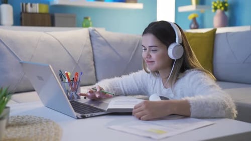 Young Woman Video Conferencing While Studying