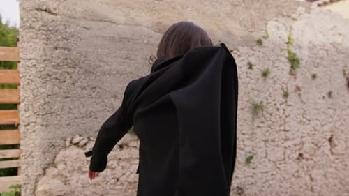 Woman Puts on Stylish Blazer Outdoors