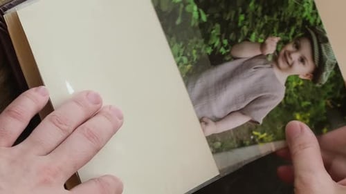 Vertical Video Hands Adding Printed Photo to Family Picture Album