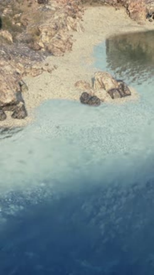Aerial View of Rocky Cliff Surrounding Body of Water