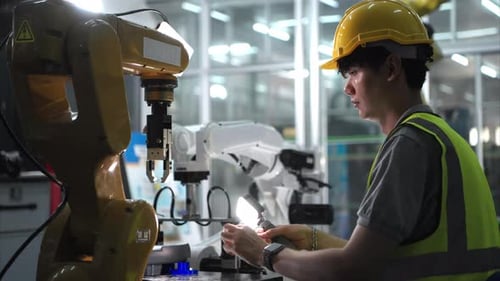 Techniker, der einen kleinen Roboterarm instandhält, die Bedienung eines kleinen Roboterarms, der in der Industrie verwendet wird
