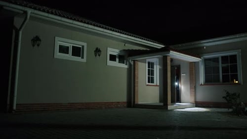 Unrecognized Man Sneaking Out of a House with Stolen Values