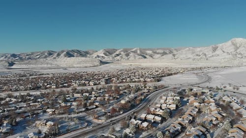 A drone pan over a residential area after a spring snow.