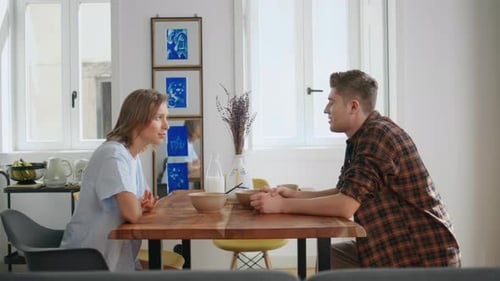 Young Couple Talking at the Breakfast Table