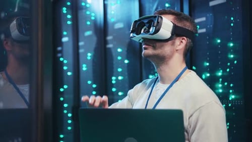 A Man in a Server Room Uses VR to Navigate Data and Environments