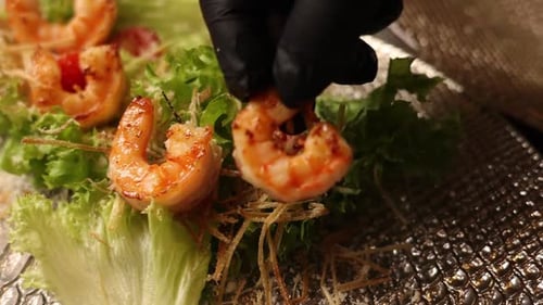 Chef prepares seafood dishes in a Japanese restaurant