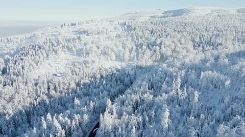 Scenic Road Through a Snowy Winter Mountain Wonderland Aerial