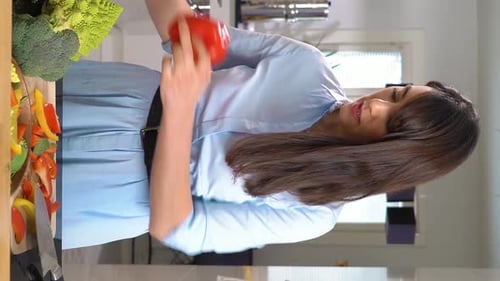 Woman Prepares Fresh Vegetables in Bright Kitchen