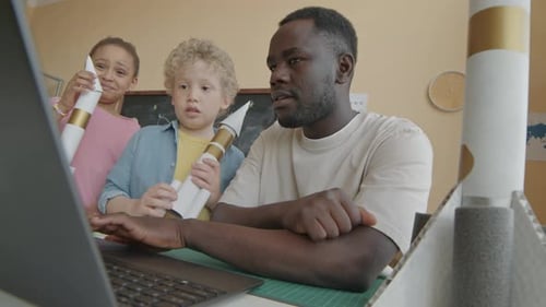 Teacher Showing Video on Laptop to Primary School Kids