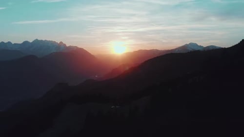 Aerial drone view flight over forest in Mountain at sunset/sunrise.