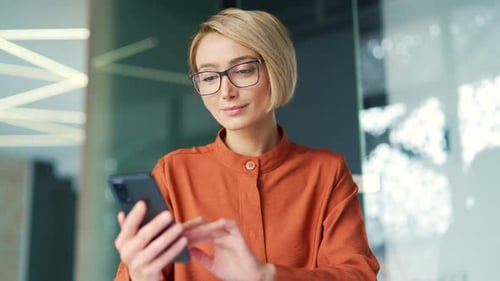 Woman Using Mobile Phone in Office Setting