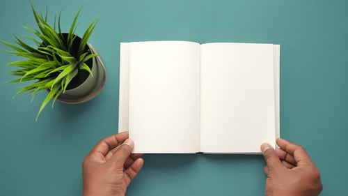 Top View of Man's Hand Turning a Pager of a Diary