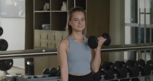 Fitness Girl Having Sport Training in Fitness Gym Female Hands Taking Bodybuilding Dumbbells in Gym
