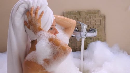 Side View of Woman Enjoys a Spa Session By Sitting in a Bathtub