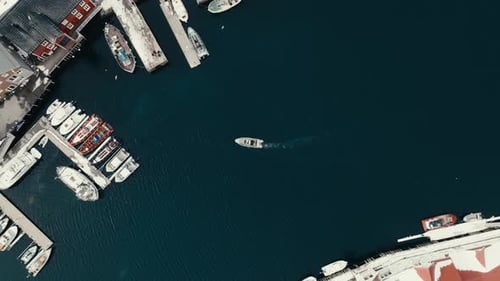 Overhead View Of Boat Cruising Towards The Marina In Henningsvaer Village In Nordland, Norway. - aer
