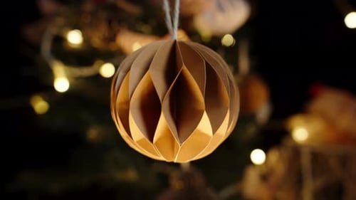 Golden Ornament Decoration on Lit Christmas Tree