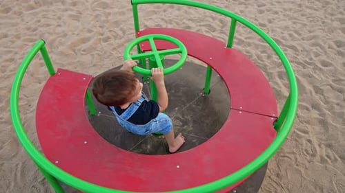 Small boy on playground having fun. Little child summer lifestyle.