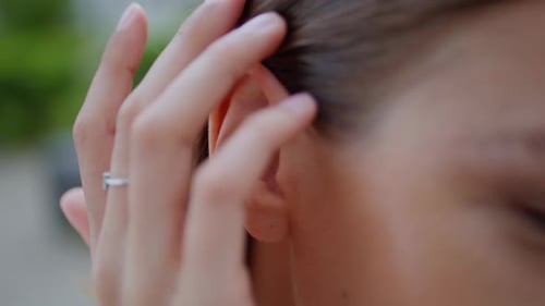 Woman Hand Fixing Hair Behind Ear Playfully at Street Closeup Girl Hairstyle