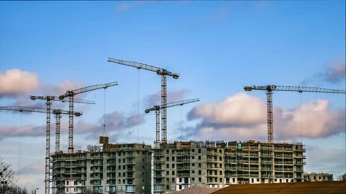 Construction Timelapse. Cranes Working On Residential Building Construction. Moving Clouds And Blue