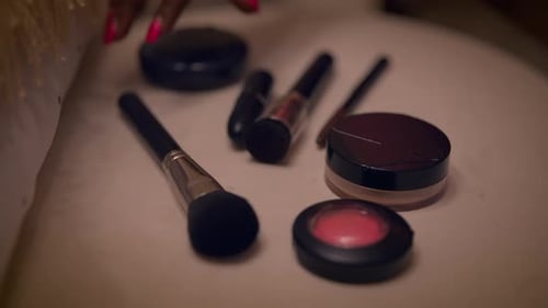 Hand Grabs Makeup Brush From Collection