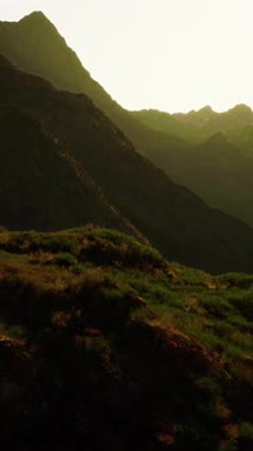 The Sun is Setting Over a Mountain Range