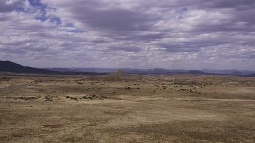 Aerial Karoo cloudy desert landscape, tracking back 4K