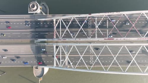 Aerial drone view of a modern highway bridge with active car traffic.