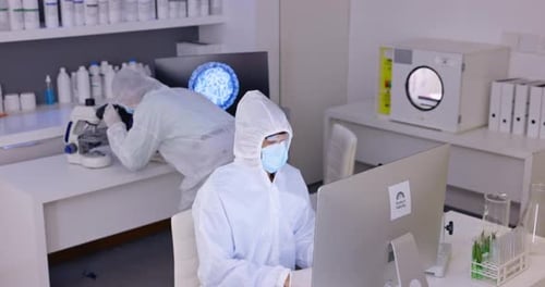 Scientists in Protective Suits Conducting Research in Laboratory