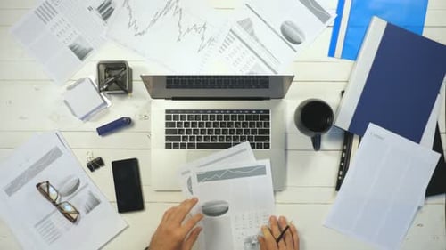 Male Hands of Manager Typing Text on Laptop Keyboard at White Desk Top View Arms of Young