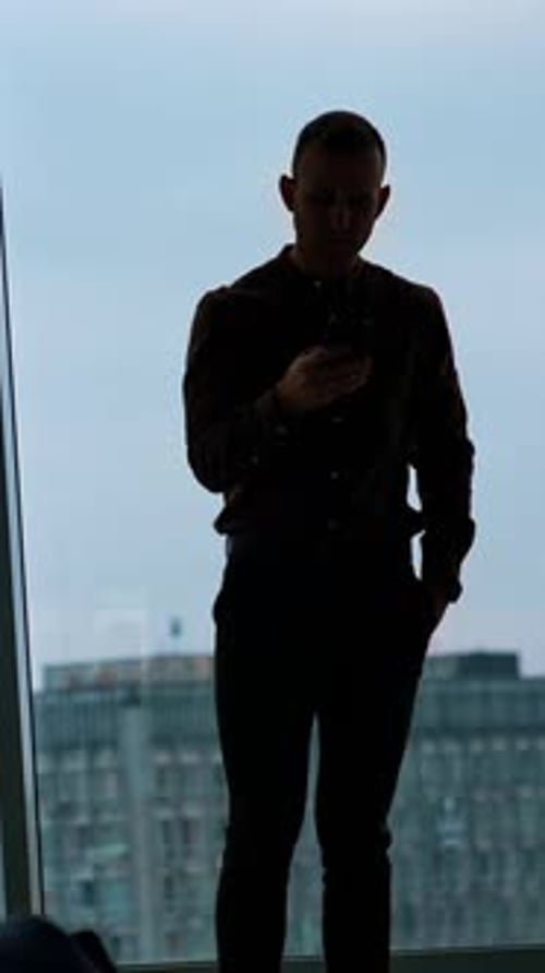 young businessman using smartphone in office Vertical video