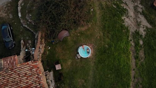 Drone Shot of Woman Lay in Steaming Wooden Hot Tub