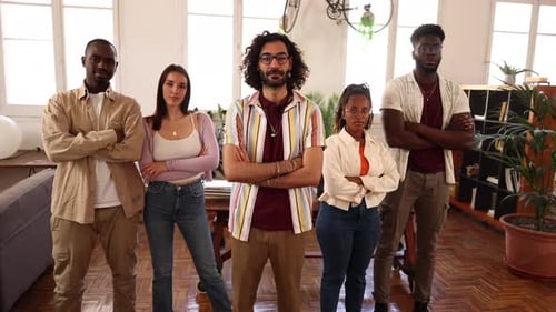 Four startup founders smiling with crossed arms in office