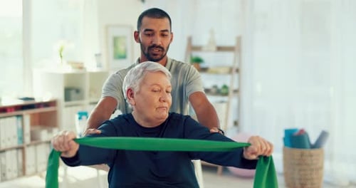Trainer Assists Senior Woman in Stretching Exercise