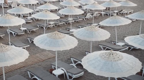 Empty Beach Rows of Folded Beach Umbrellas and Empty Sunbeds in Turkey Early Morning