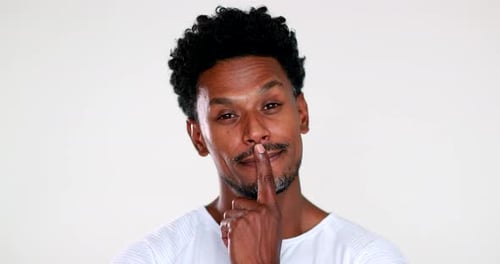 Thoughtful Man with Finger on Lip Contemplates Idea