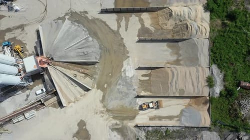 Aerial view of cement manufacturing plant. Working sand loading machines.