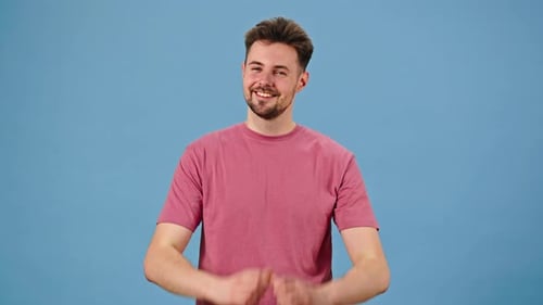 Man Makes Heart Shape with Hands Smiling