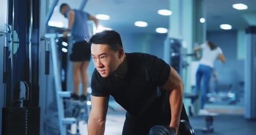 Asian Japanese Young Adult Sportsman Lifting Dumbbells on Left Arm Working with Heavy Weights in