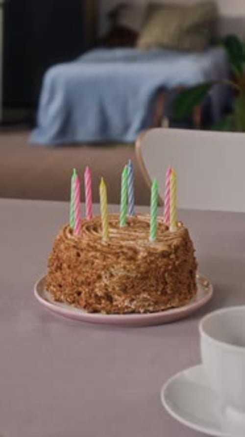 Close-up of Festive Table Set with Sponge Cake Decorated with Birthday Candles