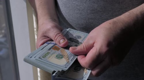 Counting Stack of One Hundred Dollar Bills