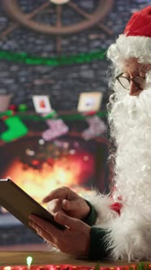 Santa Claus Using Tablet in Christmas Setting