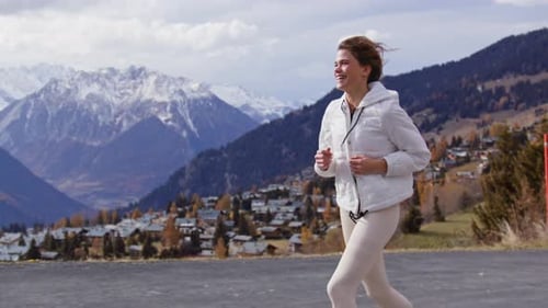 Woman running in the Swiss Alps in scenic alpine landscape